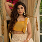 A chic off-white Hakoba Lehenga with intricate gold embroidery accented by a bold, saffron yellow blouse - Gold embroidered hakoba Shrug Optional