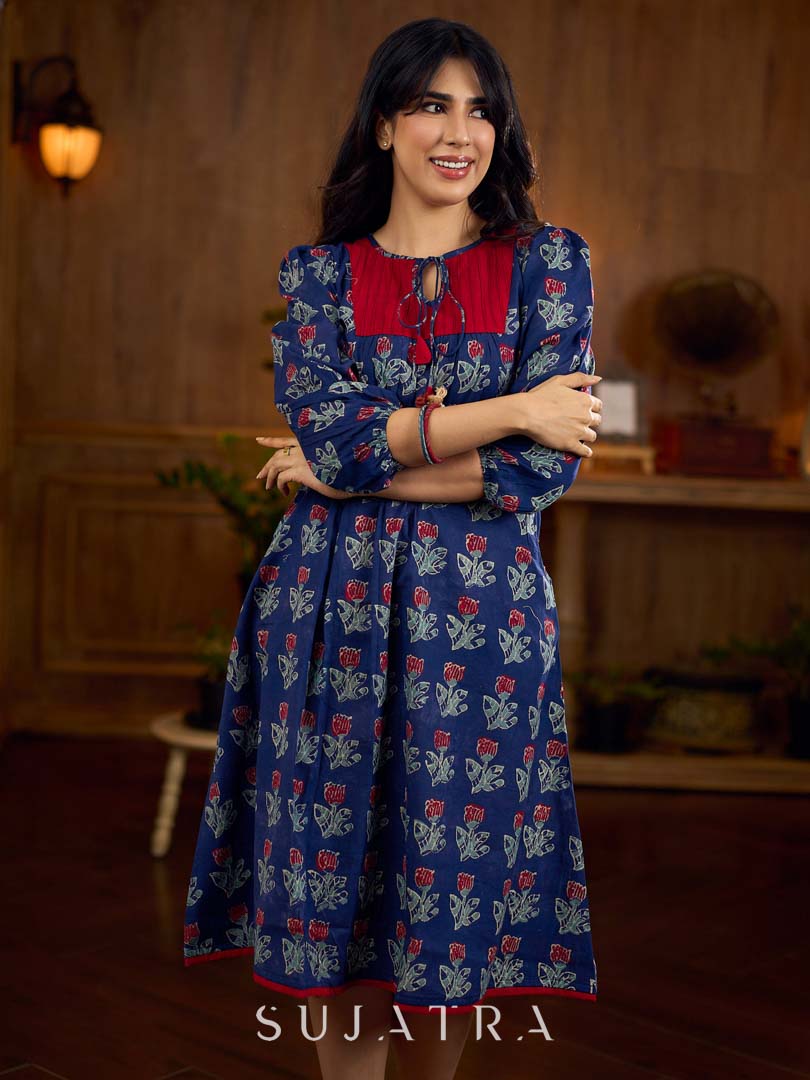 Royal blue Jaipur-printed dress featuring red rose motifs, a pintuck neck patch with red accents, and balloon 3/4th sleeves, creating a graceful silhouette with a blend of artisanal charm and contemporary elegance.