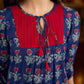 Royal blue Jaipur-printed dress featuring red rose motifs, a pintuck neck patch with red accents, and balloon 3/4th sleeves, creating a graceful silhouette with a blend of artisanal charm and contemporary elegance.