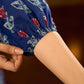 Royal blue Jaipur-printed dress featuring red rose motifs, a pintuck neck patch with red accents, and balloon 3/4th sleeves, creating a graceful silhouette with a blend of artisanal charm and contemporary elegance.