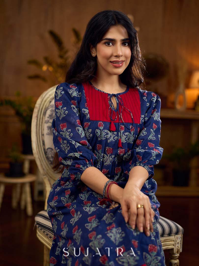 Royal blue Jaipur-printed dress featuring red rose motifs, a pintuck neck patch with red accents, and balloon 3/4th sleeves, creating a graceful silhouette with a blend of artisanal charm and contemporary elegance.