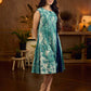 Indigo printed dress featuring playful fish motifs, designed in a gathered side-panel silhouette with contrast navy blue accents, creating a fluid, contemporary look with refined artisanal charm.