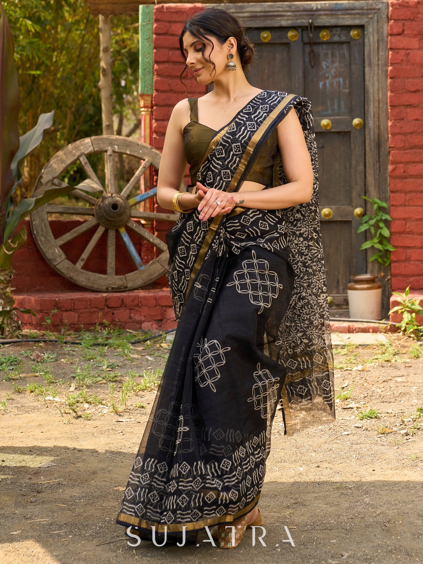 Classic black Kota saree with bold handblock prints and golden borders