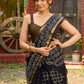 Classic black Kota saree with bold handblock prints and golden borders
