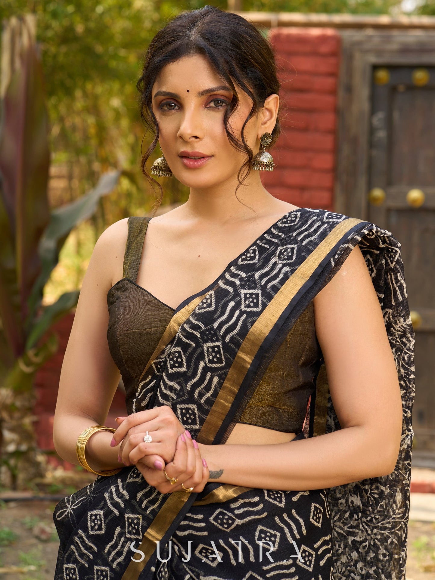 Classic black Kota saree with bold handblock prints and golden borders