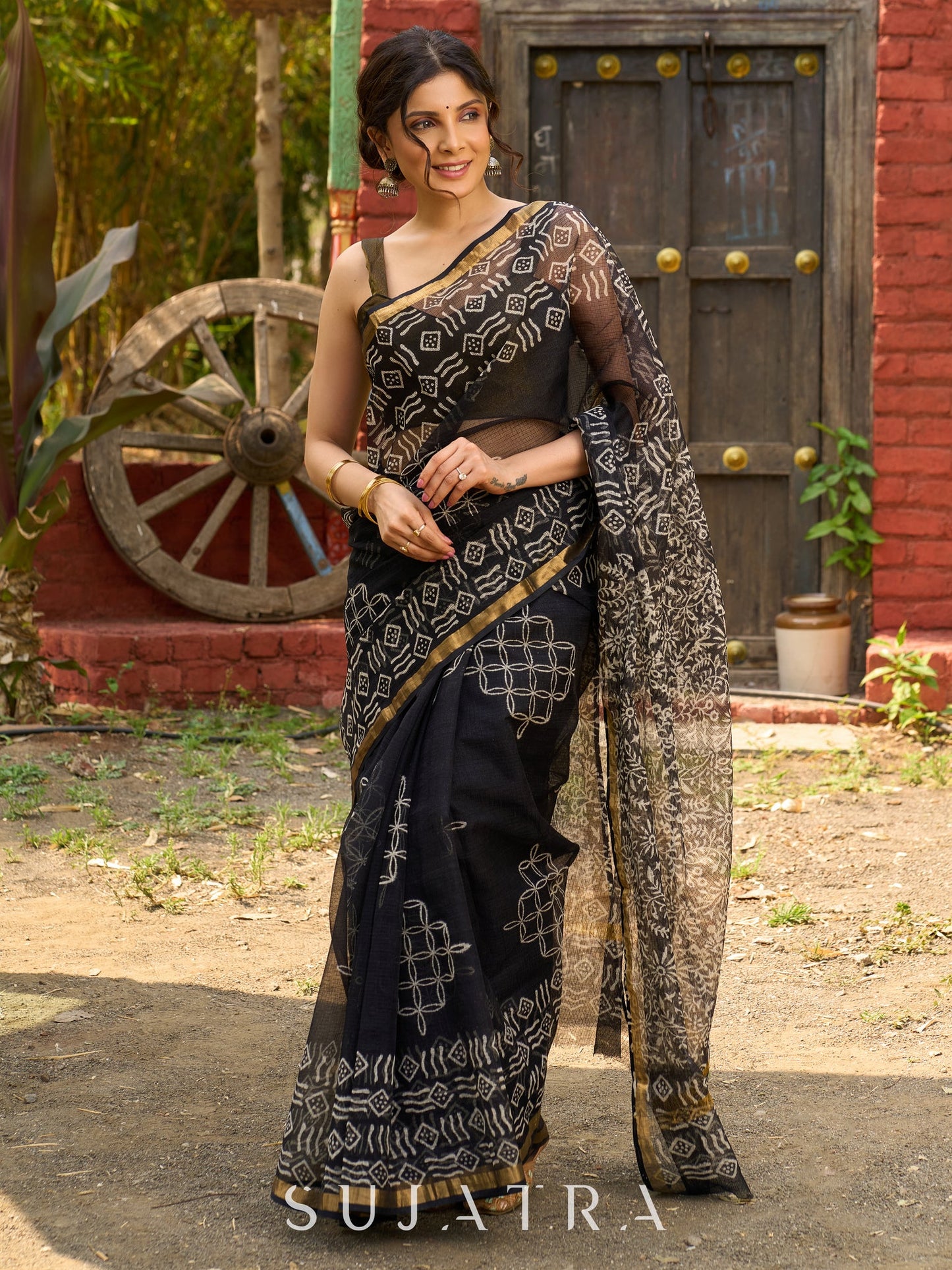 Classic black Kota saree with bold handblock prints and golden borders