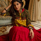 Red tiered Jamdani lehenga with a striking green Ajrakh and mustard jamdani choli featuring intricate mirror work & shell tassels .