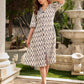 Modern white and grey Ikat shirt dress elevated with an asymmetrical checkered Ikat collar and contrast black accents.