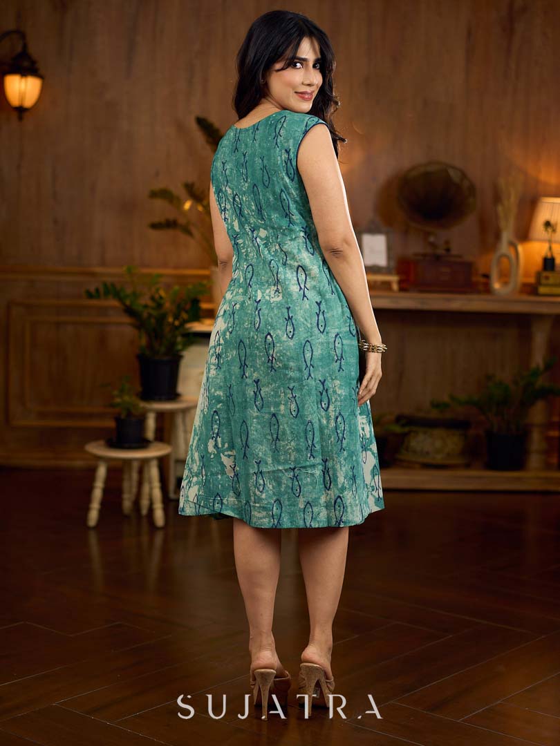Indigo printed dress featuring playful fish motifs, designed in a gathered side-panel silhouette with contrast navy blue accents, creating a fluid, contemporary look with refined artisanal charm.