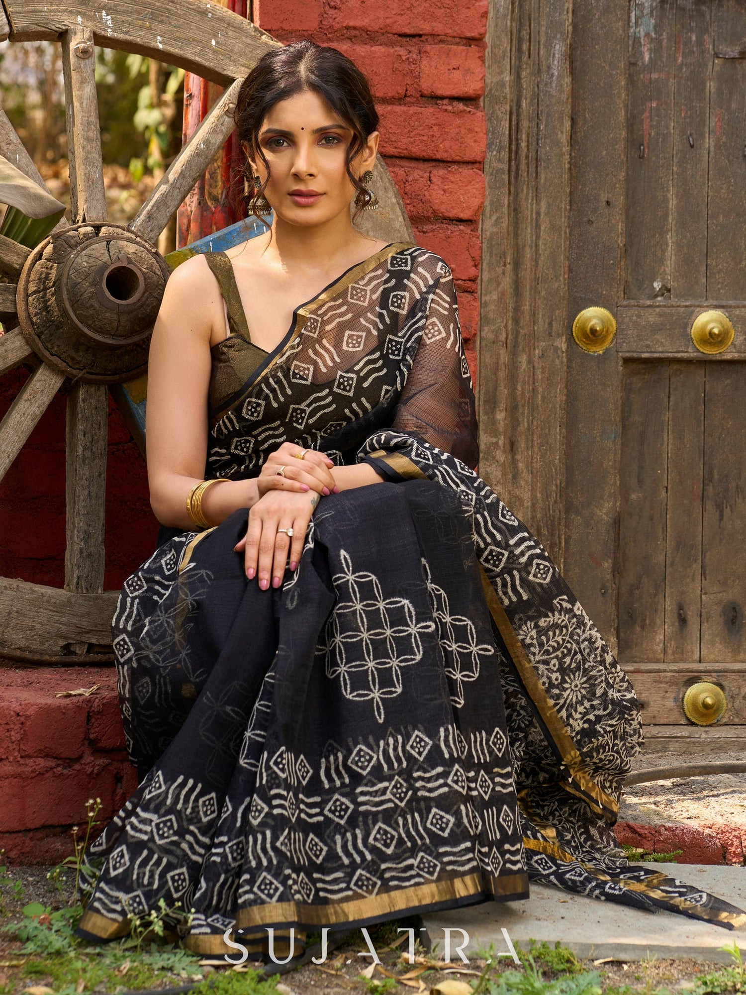 Classic black Kota saree with bold handblock prints and golden borders