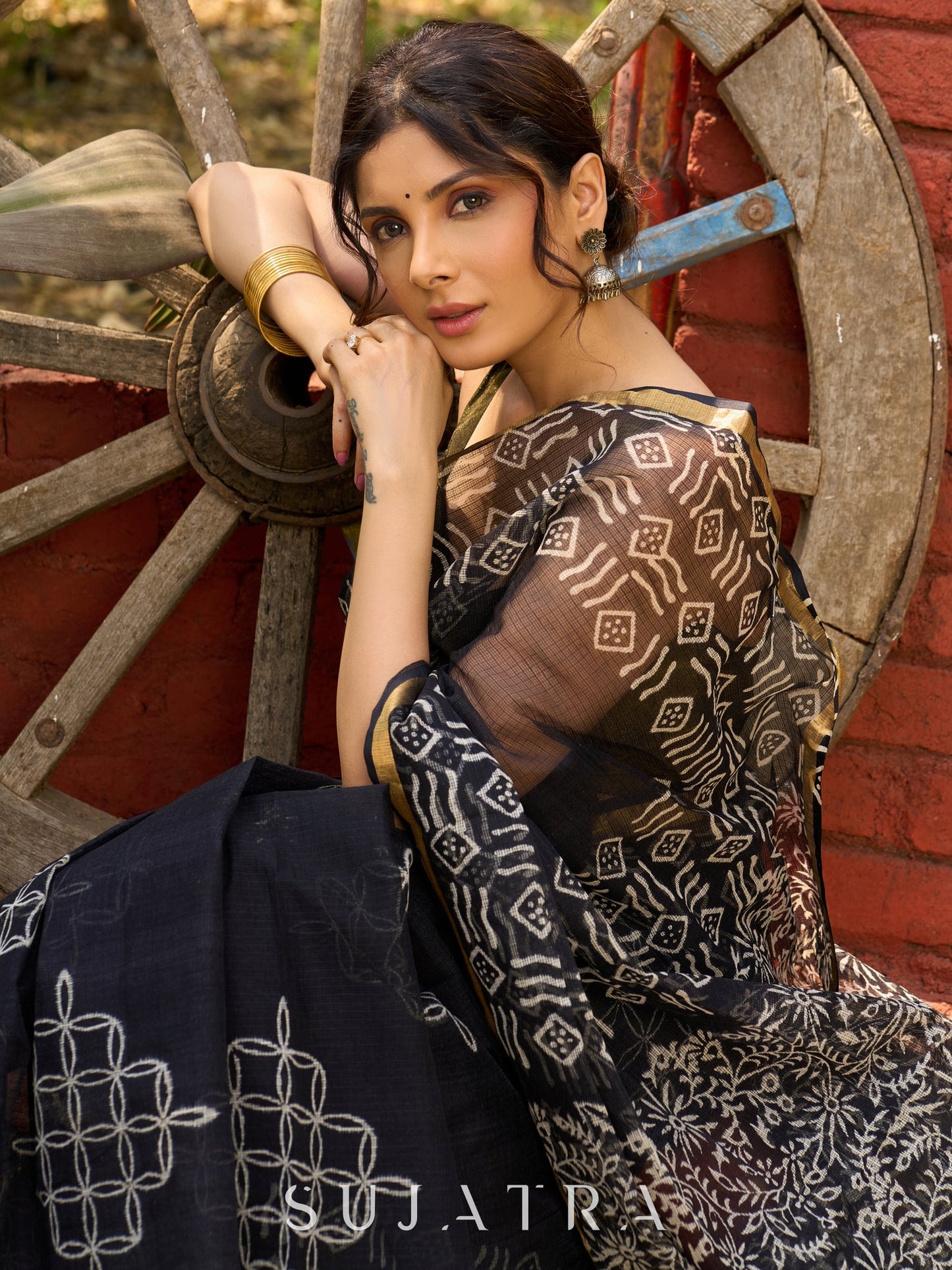 Classic black Kota saree with bold handblock prints and golden borders