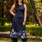 Modern black kurta blending playful polka dots and intricate Madhubani art, finished with a sleek halter neck