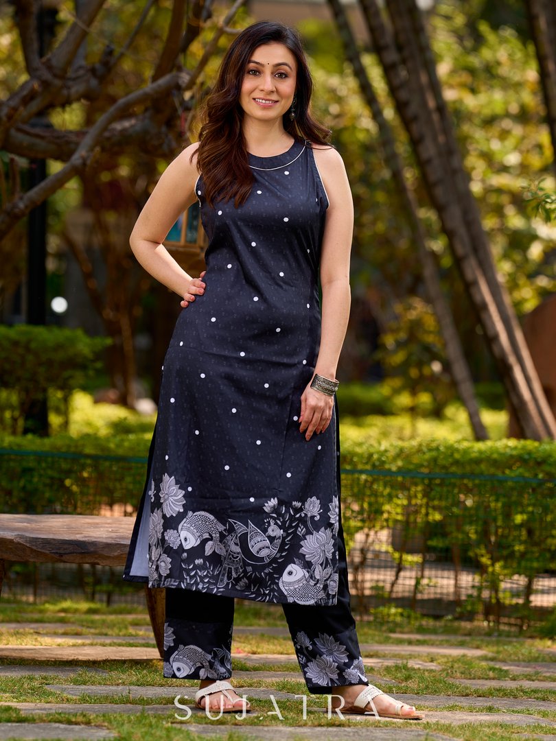 Modern black kurta blending playful polka dots and intricate Madhubani art, finished with a sleek halter neck