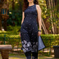 Modern black kurta blending playful polka dots and intricate Madhubani art, finished with a sleek halter neck