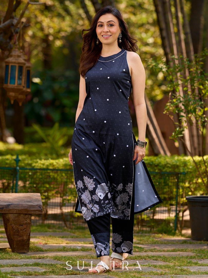 Modern black kurta blending playful polka dots and intricate Madhubani art, finished with a sleek halter neck