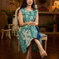 Indigo printed dress featuring playful fish motifs, designed in a gathered side-panel silhouette with contrast navy blue accents, creating a fluid, contemporary look with refined artisanal charm.