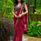 Artisanal maroon Jamdani saree elevated with zari-bordered detailing