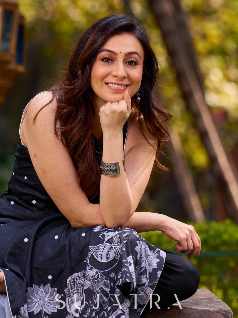 Modern black kurta blending playful polka dots and intricate Madhubani art, finished with a sleek halter neck