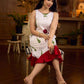 White sleeveless dress featuring red butta motifs and a gathered red panel at the hem, finished with coordinated red accents for a fresh, playful silhouette with a touch of traditional charm.