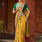 Exquisite Mustard Bandhani Print Saree with Green Benarasi Border & Tasseled Pallu with Hand Embroidered Mirror Work