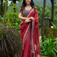 Artisanal maroon Jamdani saree elevated with zari-bordered detailing