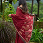 Artisanal maroon Jamdani saree elevated with zari-bordered detailing