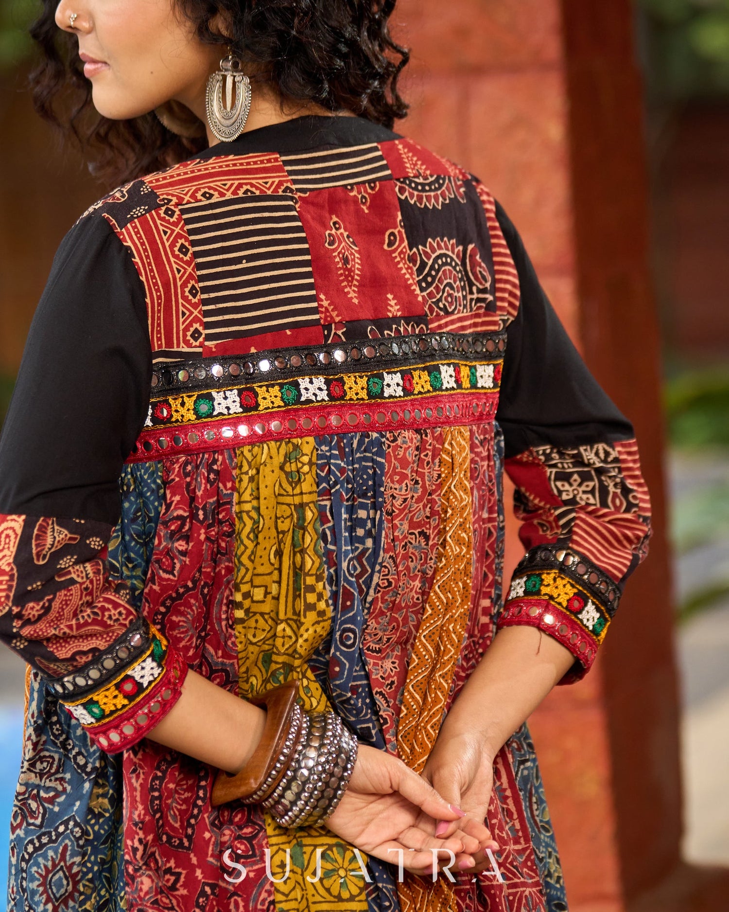 Black Rayon Double-Flared Sleeveless Dress with Mirror Work Embellishments  -  Patchwork Ajrakh Jacket Additional