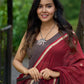 Artisanal maroon Jamdani saree elevated with zari-bordered detailing