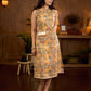 Summery mustard and peach floral sleeveless dress featuring a boat neckline and Hakoba pocket detailing, finished with soft off-white accents for a breezy, cheerful silhouette perfect for warm days.