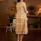 Summery mustard and peach floral sleeveless dress featuring a boat neckline and Hakoba pocket detailing, finished with soft off-white accents for a breezy, cheerful silhouette perfect for warm days.