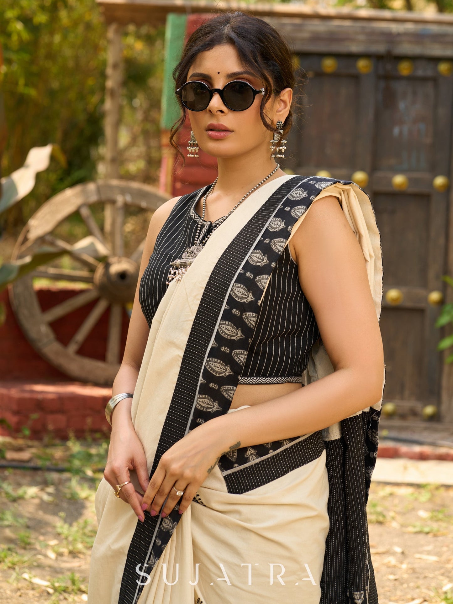 Ivory cotton saree with bold block embroidered motifs and refined contrast detailing
