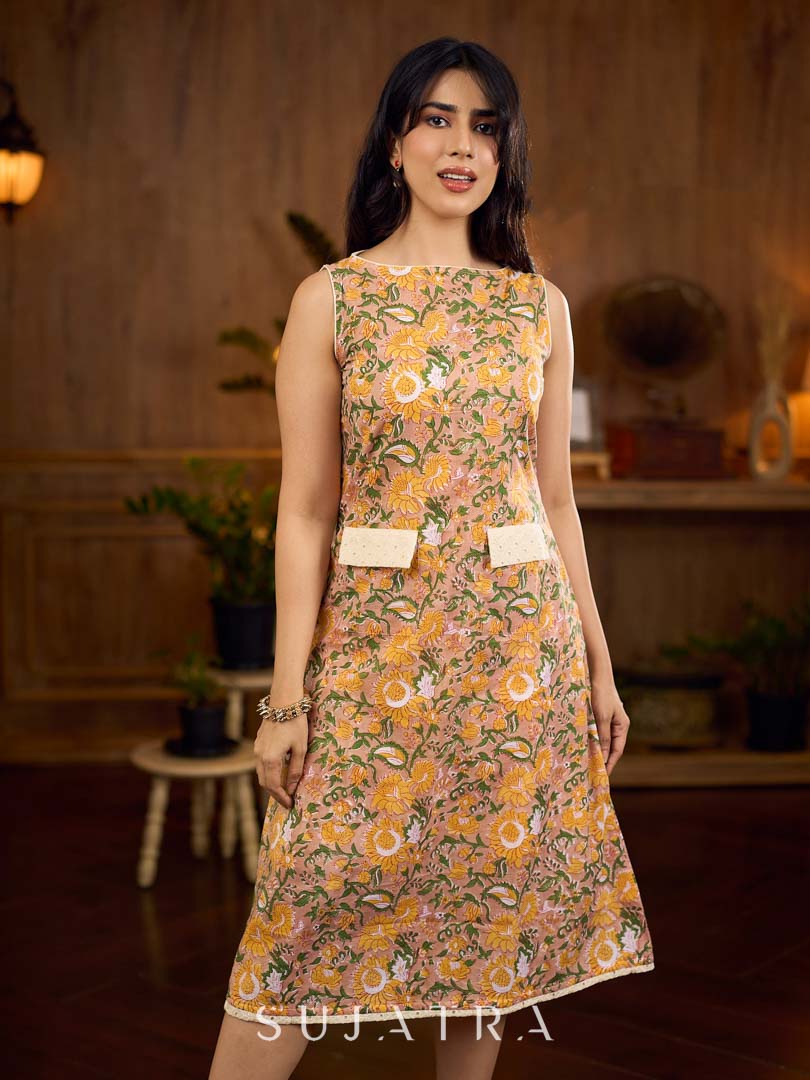 Summery mustard and peach floral sleeveless dress featuring a boat neckline and Hakoba pocket detailing, finished with soft off-white accents for a breezy, cheerful silhouette perfect for warm days.
