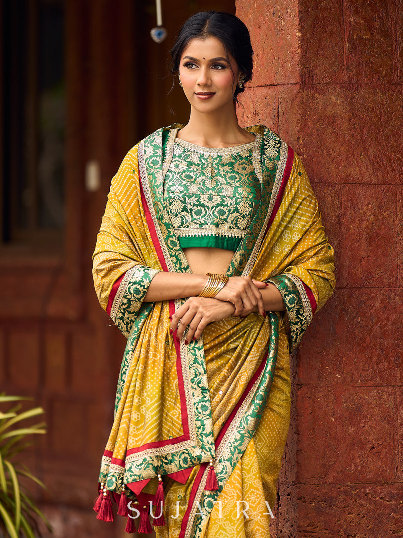 Exquisite Mustard Bandhani Print Saree with Green Benarasi Border & Tasseled Pallu with Hand Embroidered Mirror Work