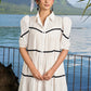 Graceful white cotton flared one piece dress highlighted with velvet lace