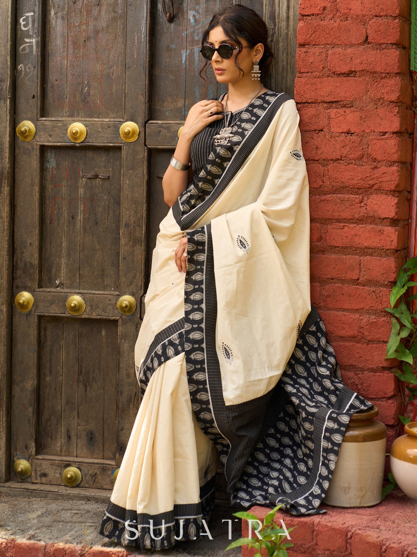Ivory cotton saree with bold block embroidered motifs and refined contrast detailing