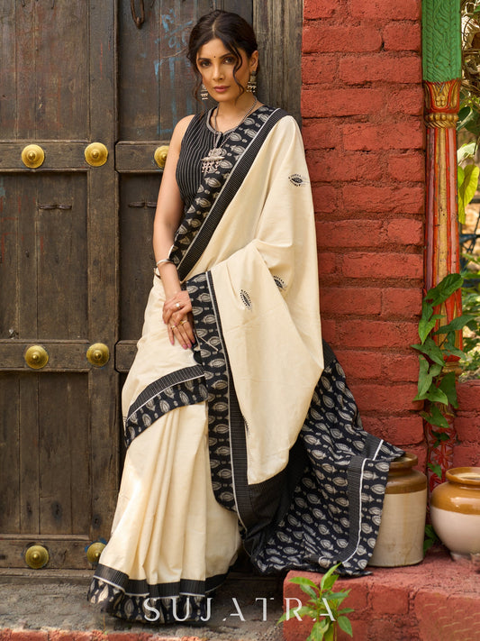 Ivory cotton saree with bold block embroidered motifs and refined contrast detailing
