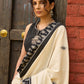 Ivory cotton saree with bold block embroidered motifs and refined contrast detailing