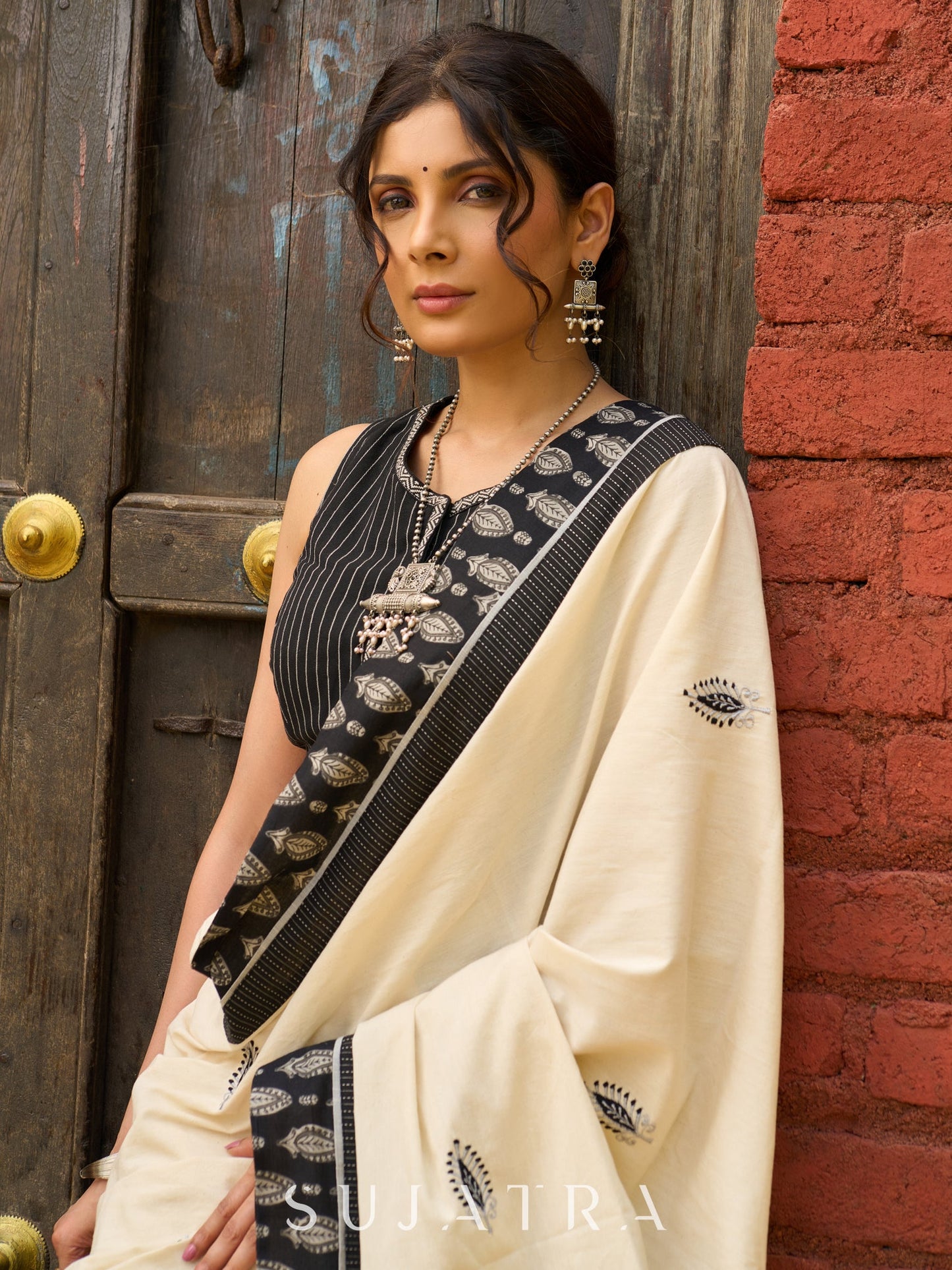 Ivory cotton saree with bold block embroidered motifs and refined contrast detailing