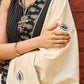 Ivory cotton saree with bold block embroidered motifs and refined contrast detailing