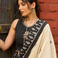 Ivory cotton saree with bold block embroidered motifs and refined contrast detailing