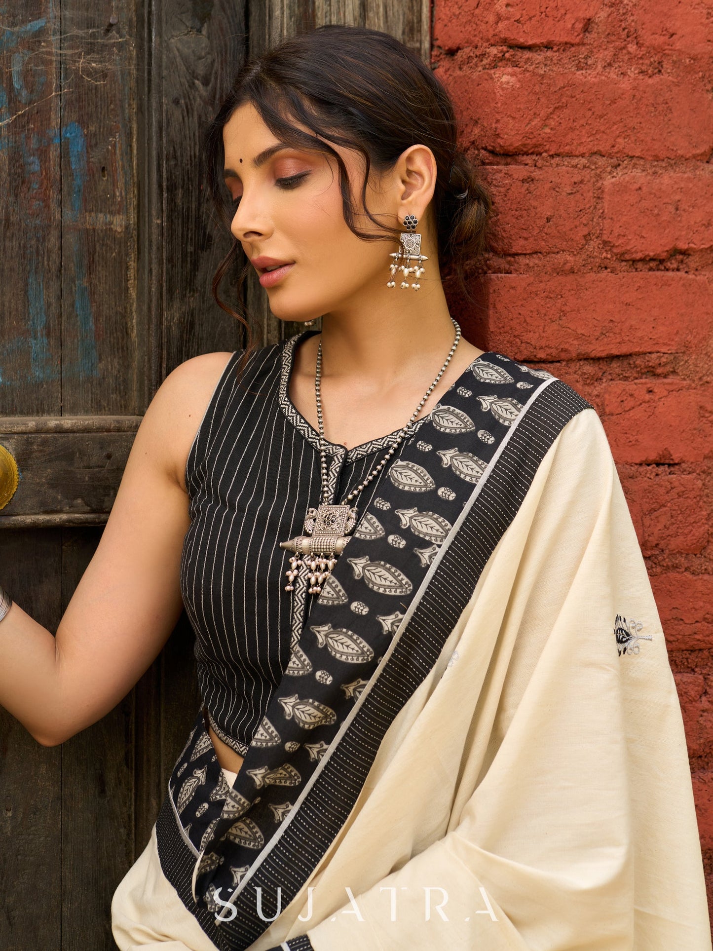 Ivory cotton saree with bold block embroidered motifs and refined contrast detailing