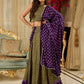 Vibrant Mehendi green and purple bandhani lehenga paired with a mirror work halter neck choli and matching dupatta.
