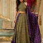 Vibrant Mehendi green and purple bandhani lehenga paired with a mirror work halter neck choli and matching dupatta.