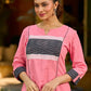 Vibrant pink short kurta elevated with a handcrafted black ikat neckline accent and folded cuffs.