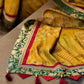 Exquisite Mustard Bandhani Print Saree with Green Benarasi Border & Tasseled Pallu with Hand Embroidered Mirror Work