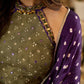 Vibrant Mehendi green and purple bandhani lehenga paired with a mirror work halter neck choli and matching dupatta.