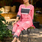 Vibrant pink short kurta elevated with a handcrafted black ikat neckline accent and folded cuffs.