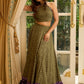 Vibrant Mehendi green and purple bandhani lehenga paired with a mirror work halter neck choli and matching dupatta.