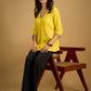 Traditional madhubani hand painting enhances this bright yellow cotton top.