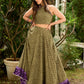 Vibrant Mehendi green and purple bandhani lehenga paired with a mirror work halter neck choli and matching dupatta.